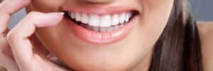 smiling woman showing off teeth after cosmetic dentistry services