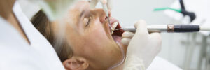 Man With Gums Disease Getting Treated by Dentist in Chair