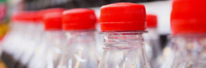 soft drinks bottles on shelves in supermarket that could hurt teeth enamel