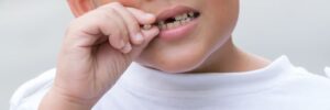 Young boy wiggling his loose tooth