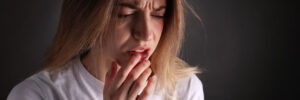 Woman dealing with pain from an abscess tooth